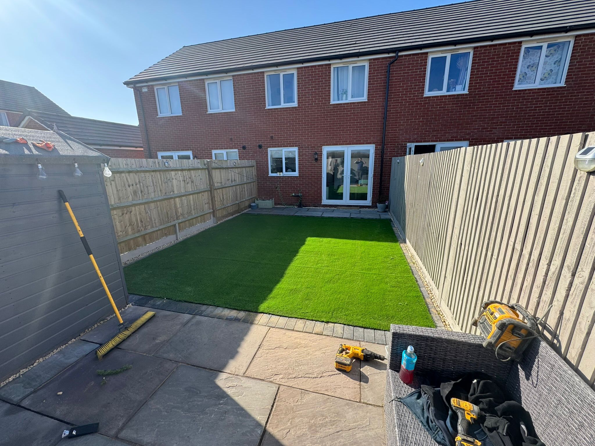 Artificial grass installation with paving