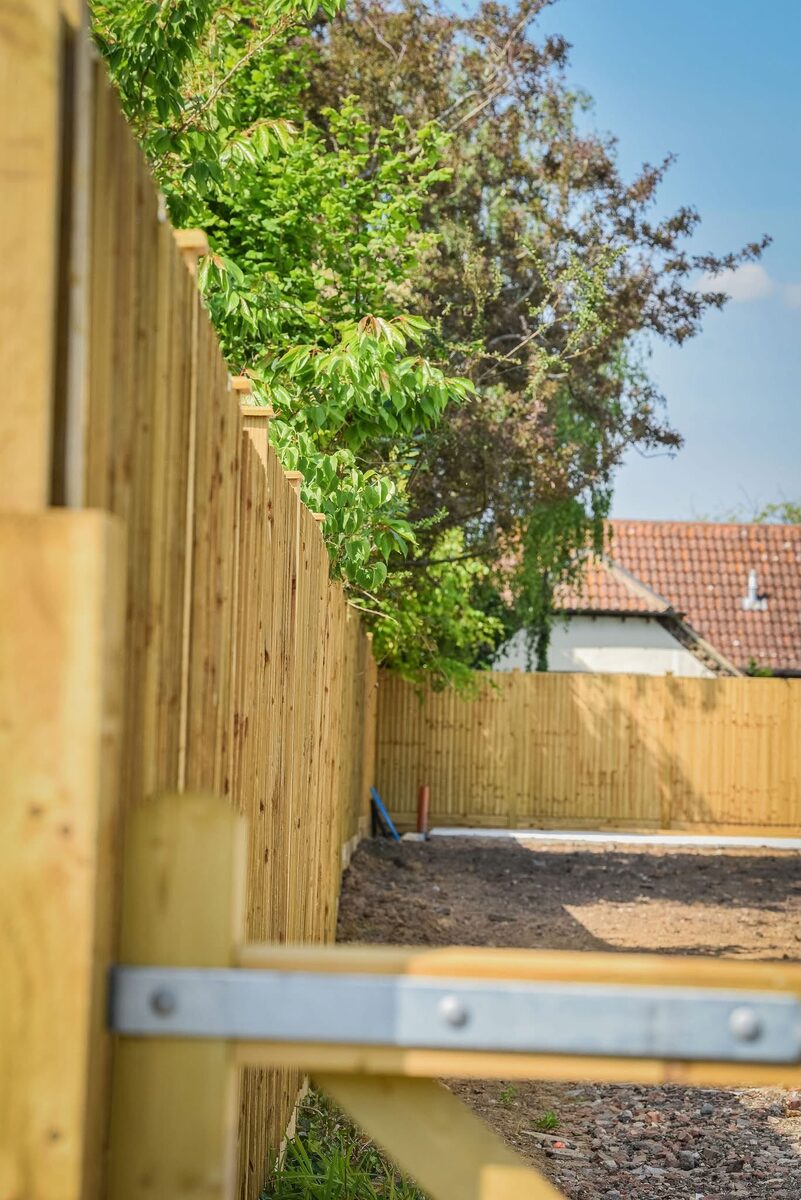Featheredge boundary fencing with timber gate
