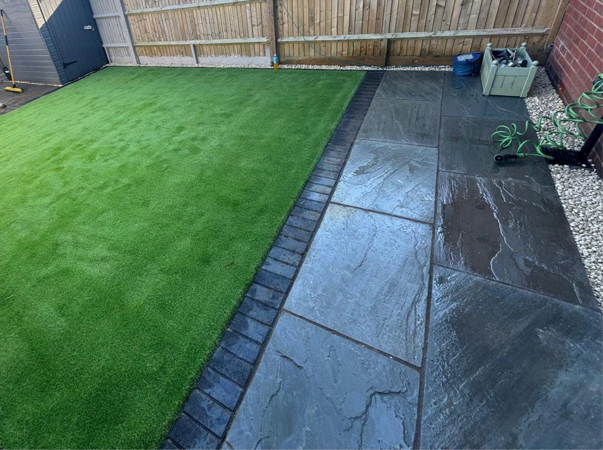 Artificial grass with paving and brick edging